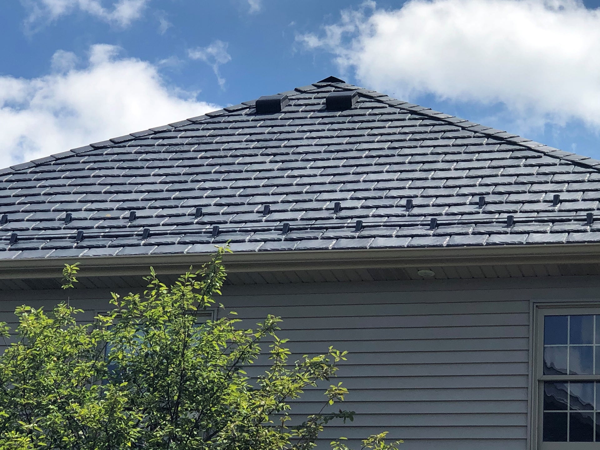 Steep slate tile roof with Cold Rolled Steel Fusion-Guard Pad-style Snow Guard.
