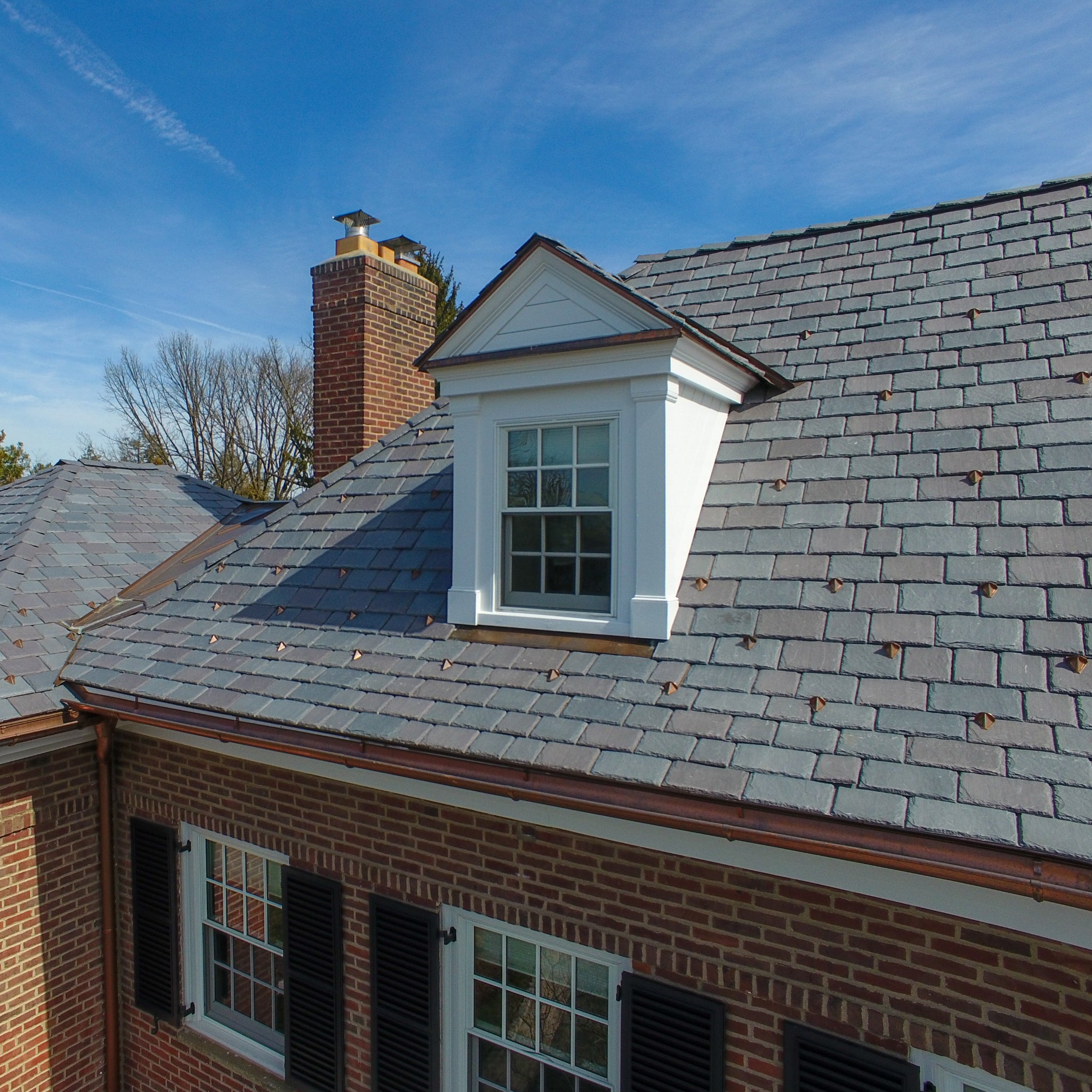 PD10 pad-style snow guards installed on natural slate.